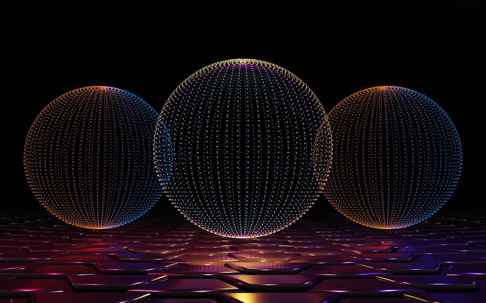 three balls of different sizes on a black background