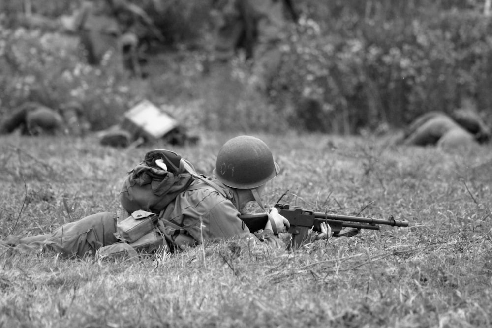 a couple of soldiers laying on top of a field