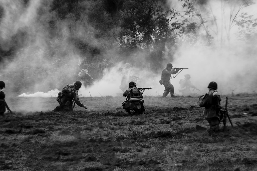 a group of men with guns in a field