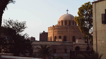 a large building with a cross on top of it