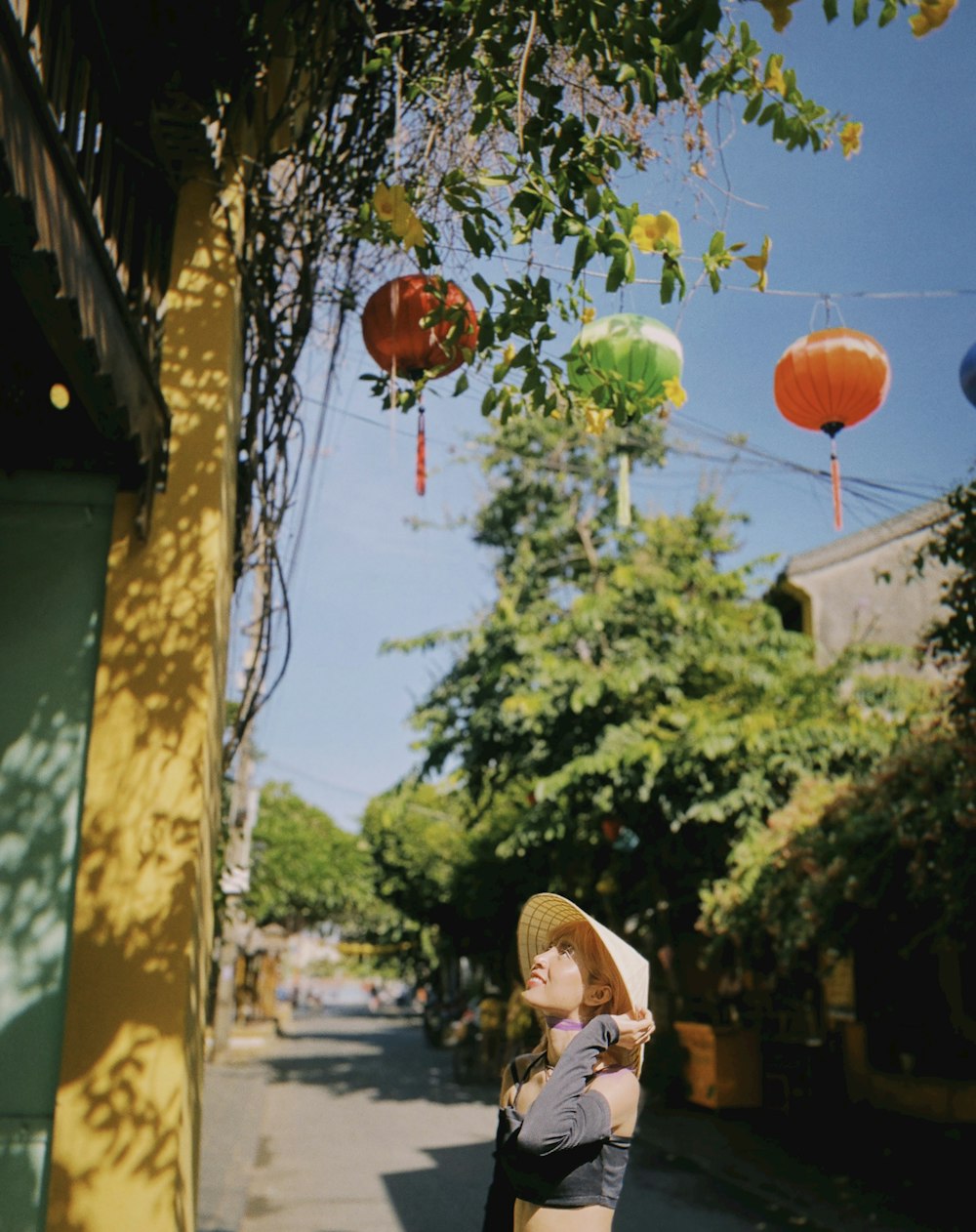 a woman standing on the side of a road