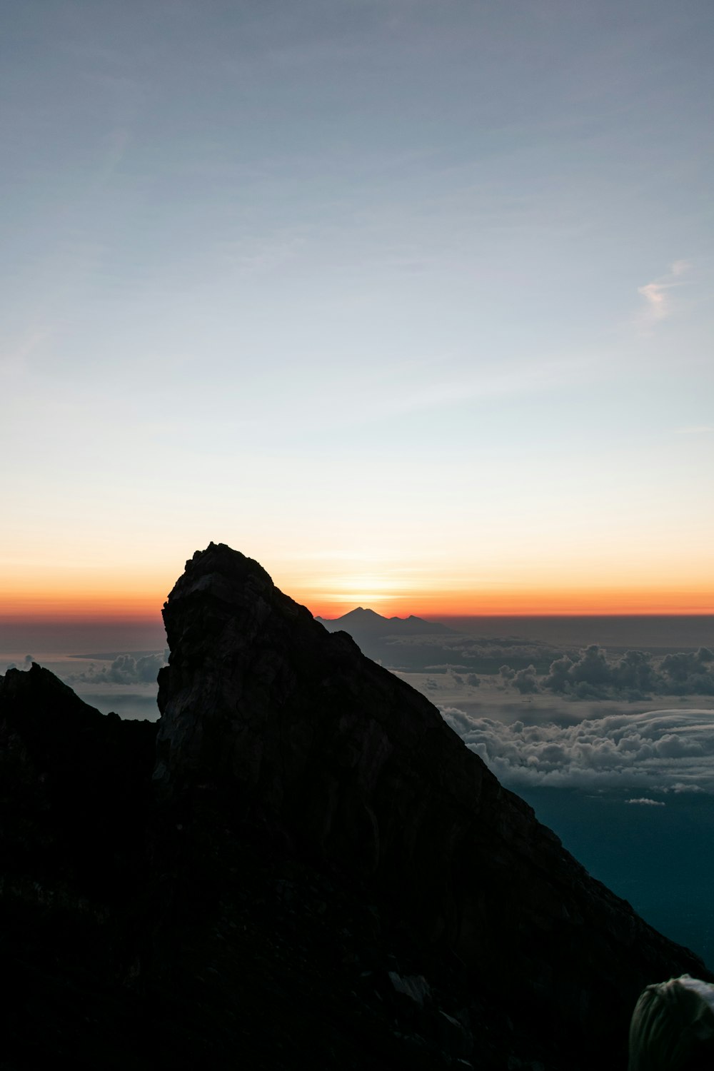 a person standing on top of a mountain at sunset