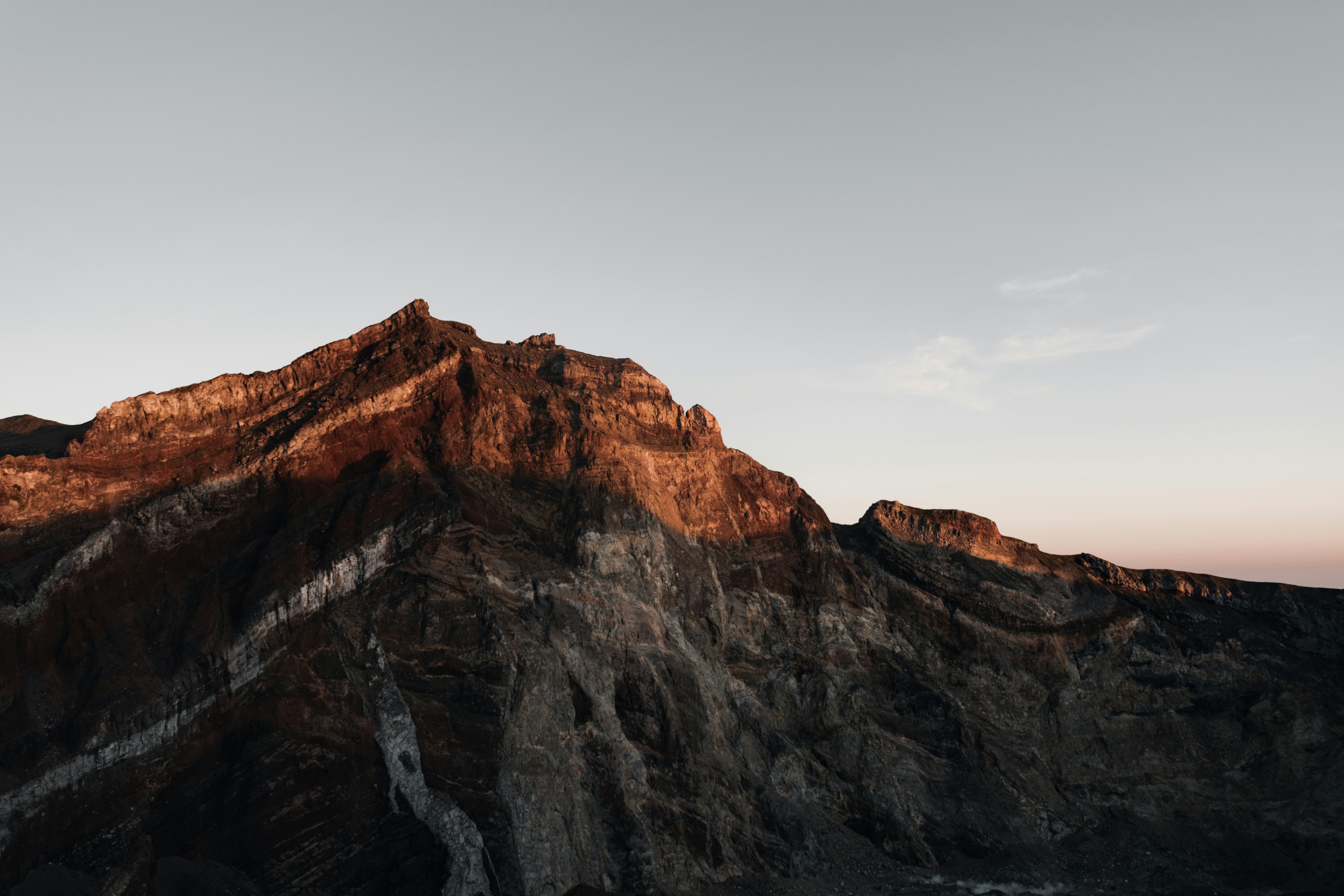 a very tall mountain with a sky in the background, Sunrise on the volcano.