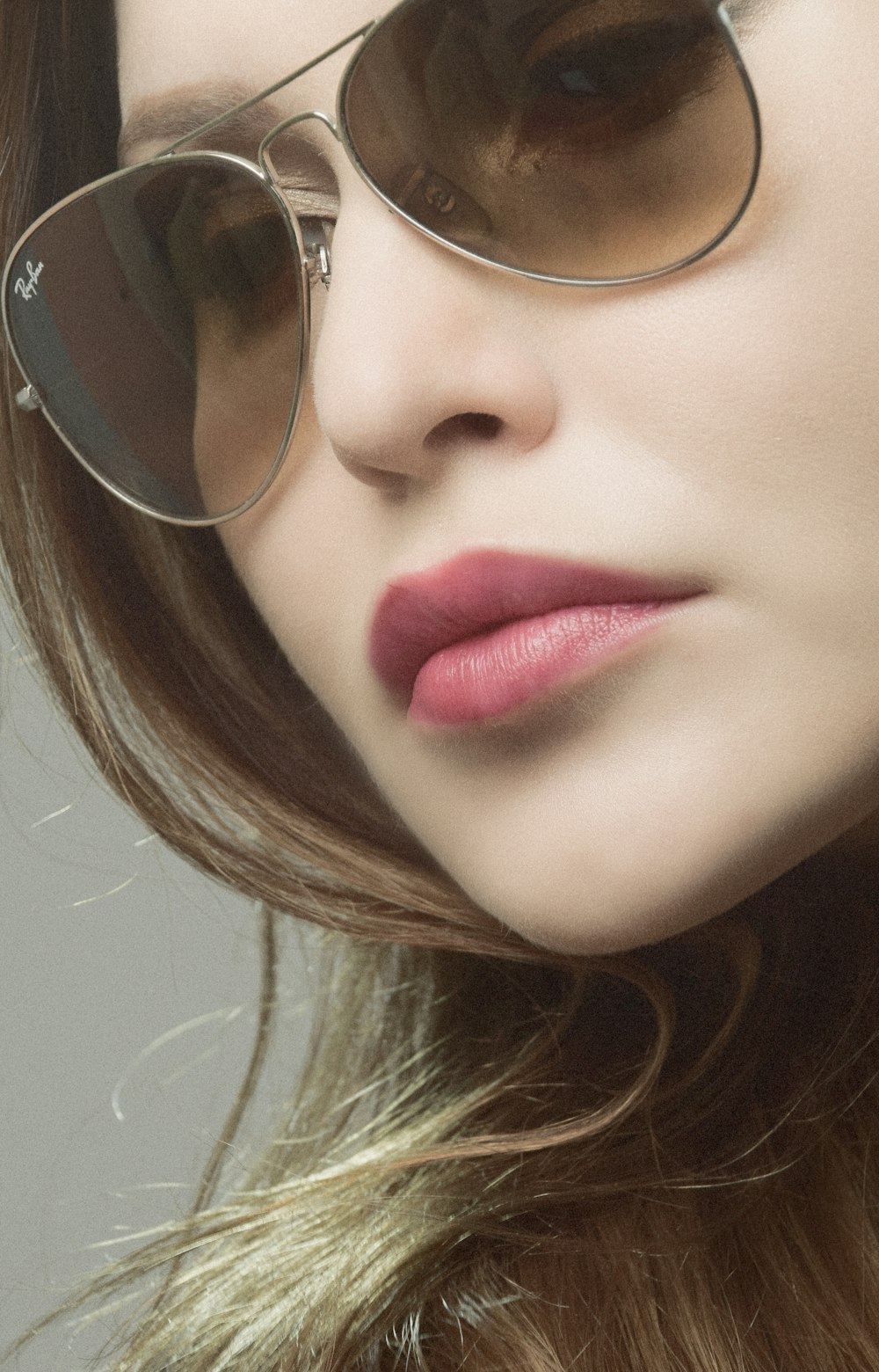 a close up of a woman wearing a pair of sunglasses