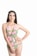 A woman with long dark hair is wearing a floral-patterned swimsuit and a small tiara. She stands confidently with one hand on her hip, set against a plain white background.