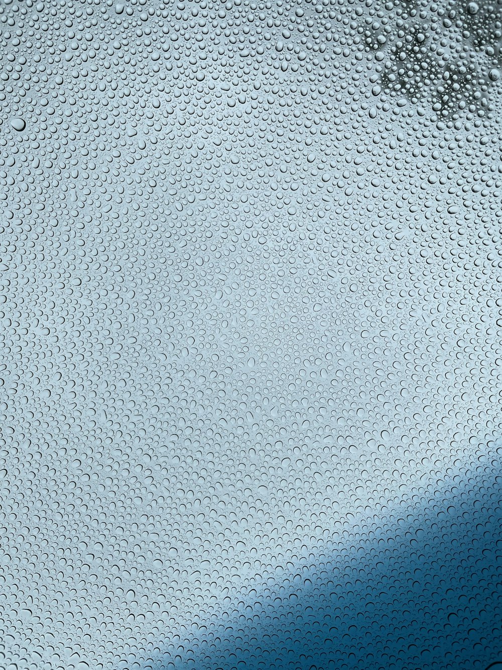 a close up of a window with water drops on it