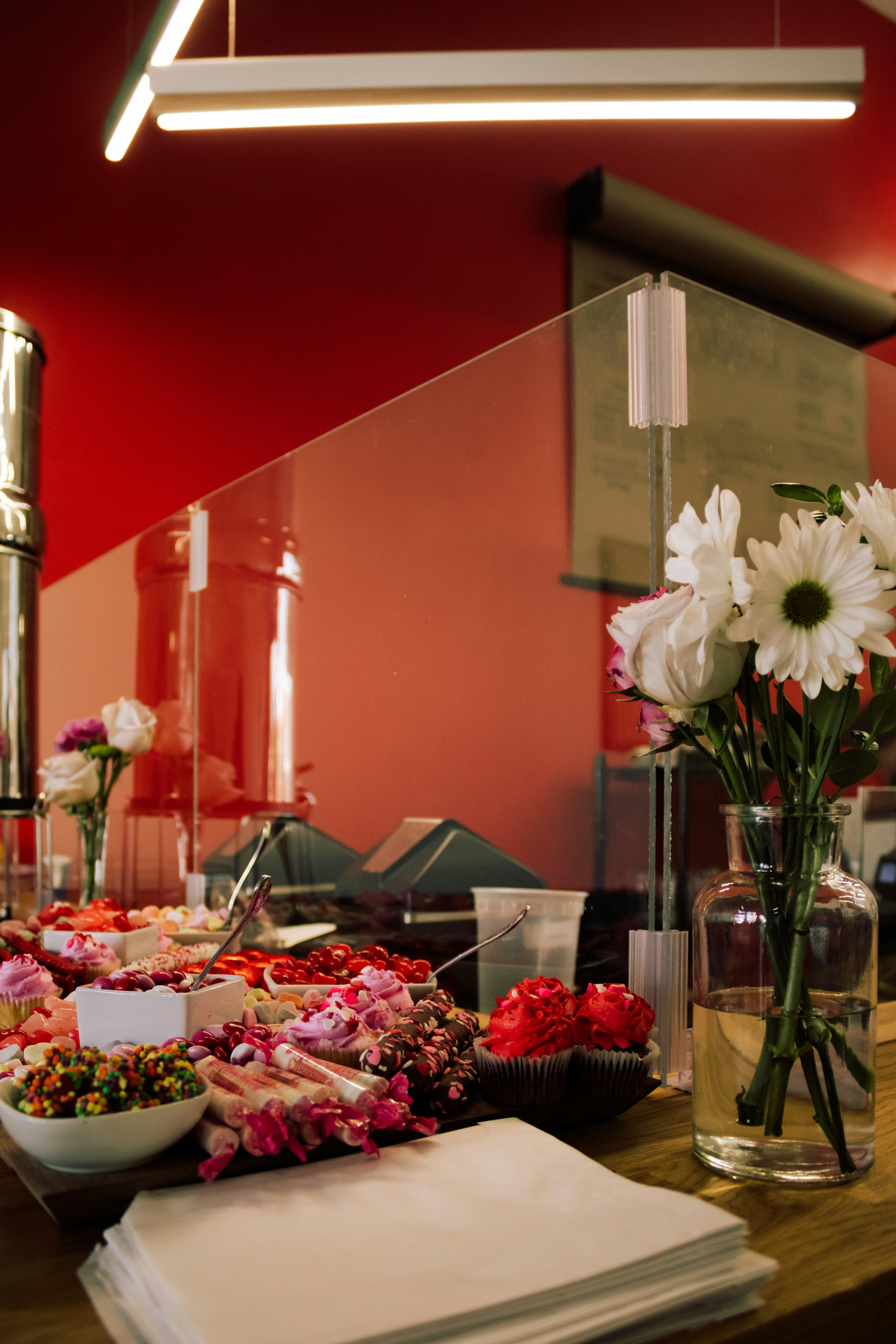 a table topped with a bowl of food and a vase filled with flowers