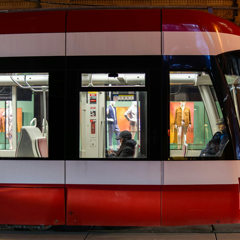 a red and white train with its doors open