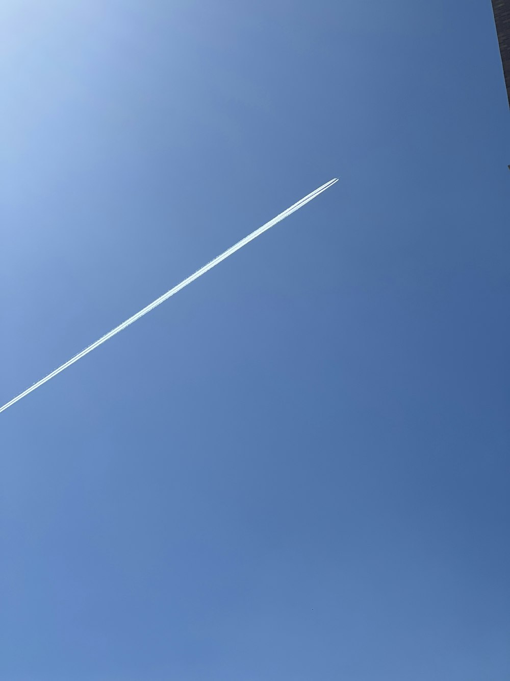 an airplane is flying in the blue sky