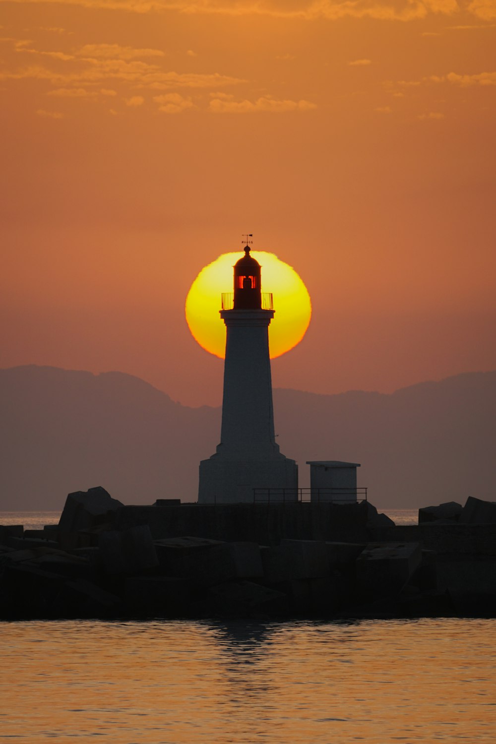 a light house sitting on top of a body of water