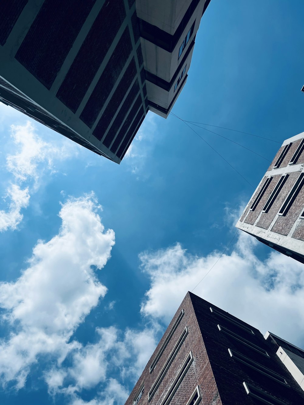 looking up at a building with a kite in the air