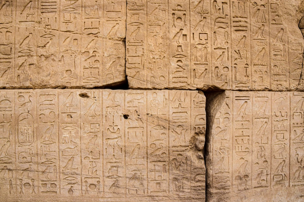 a close up of a stone wall with writing on it