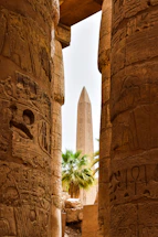 a view of the obelisk from between two columns