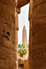 a view of the obelisk from between two columns