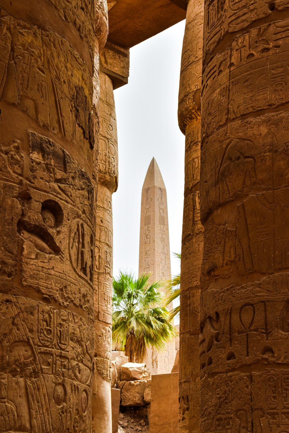 a view of the obelisk from between two columns