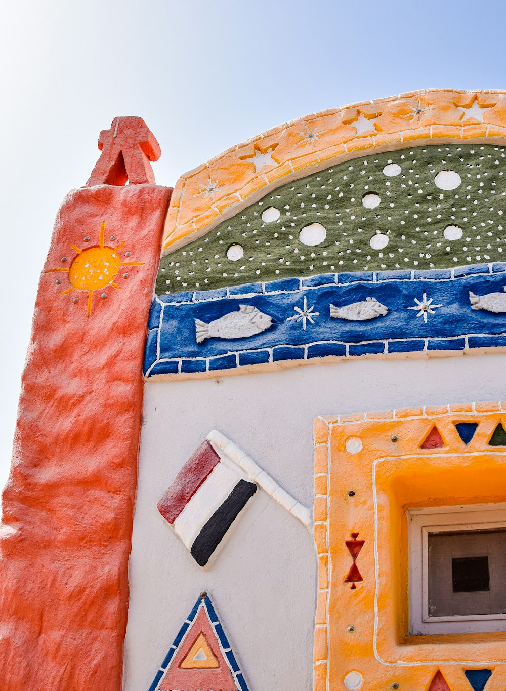 a close up of a colorful building with a sky background
