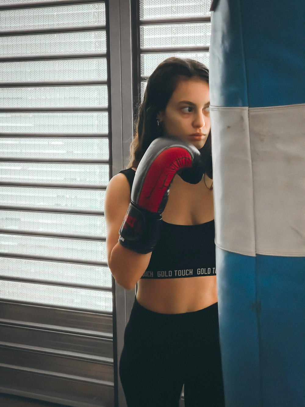 a woman in a sports bra and boxing gloves