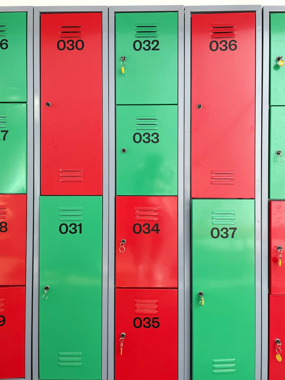 a row of red and green lockers sitting next to each other