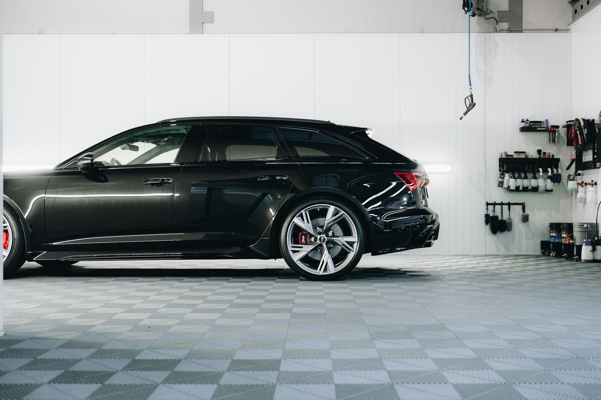 a black car is parked in a garage