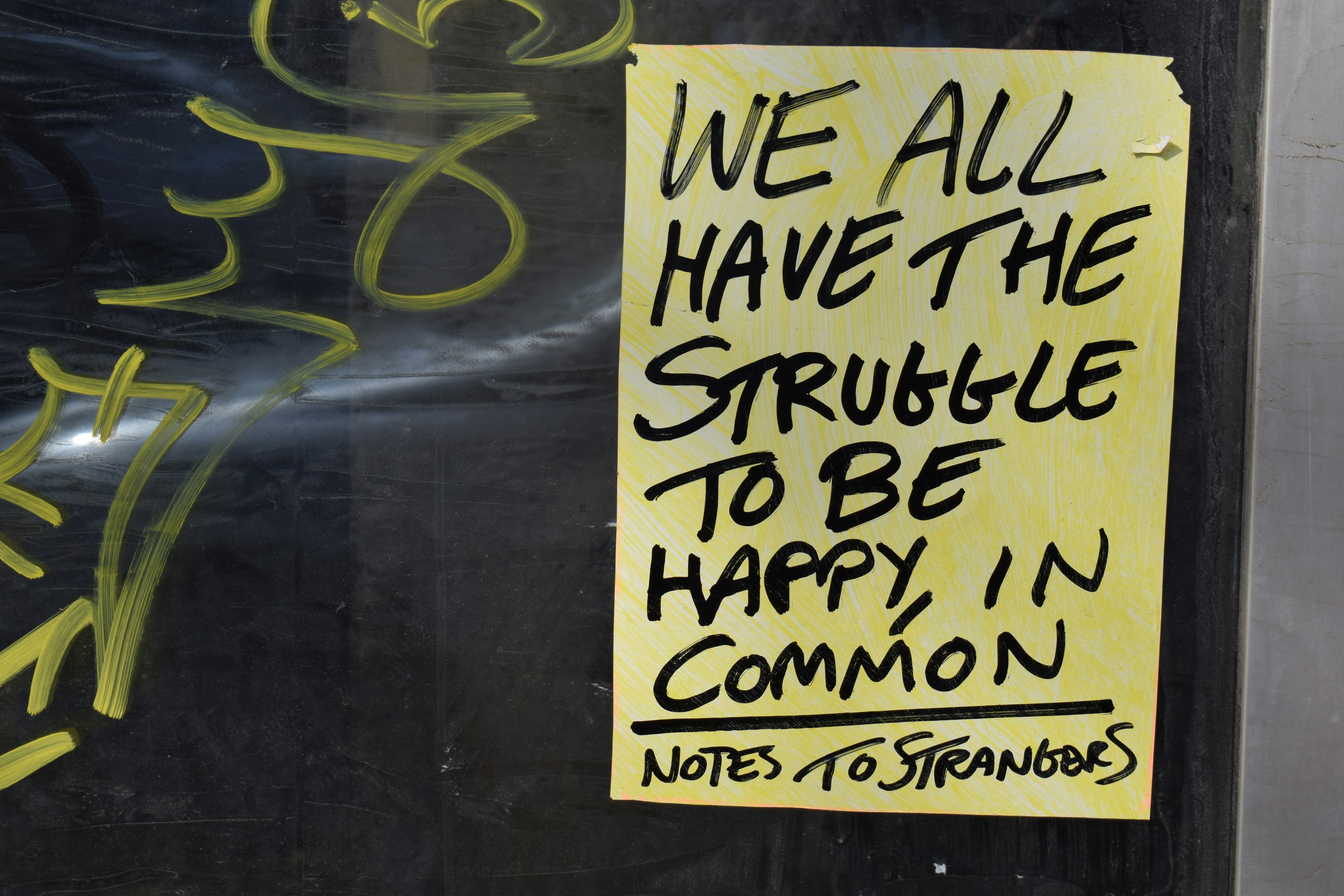 a sign on a door that says we all have the struggle to be happy in