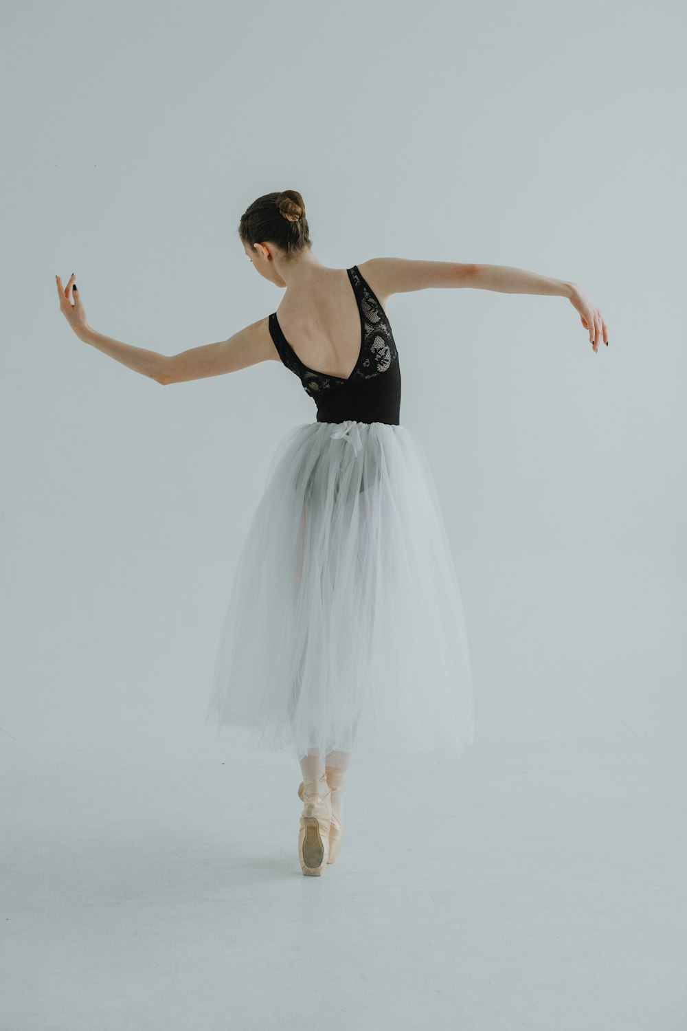a woman in a tutu and ballet shoes