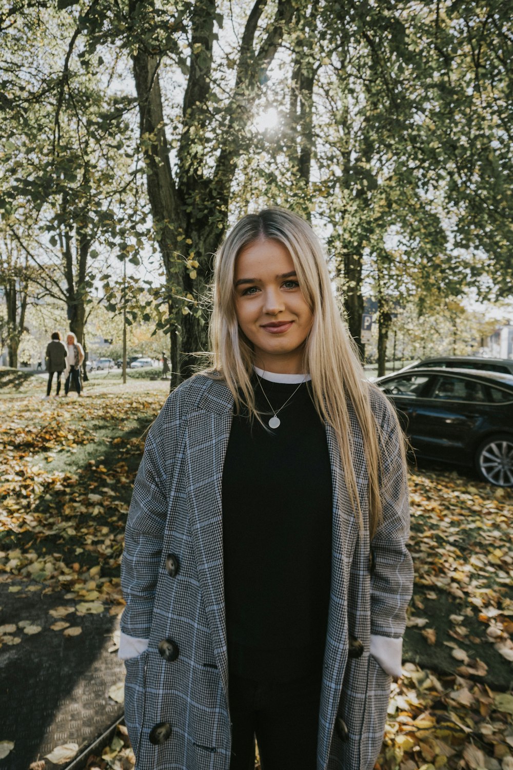 a woman standing in front of a tree