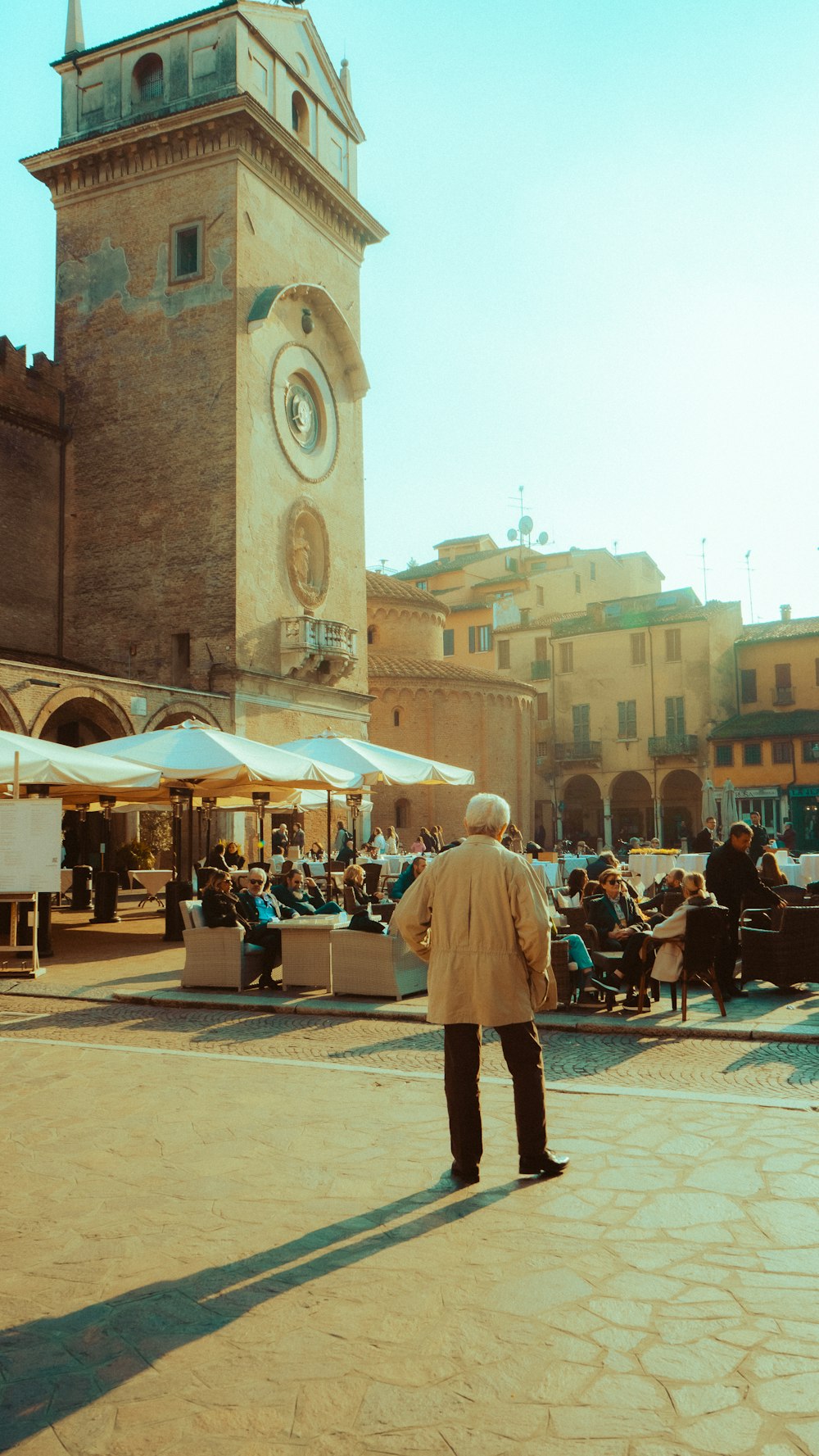 a man standing in front of a clock tower