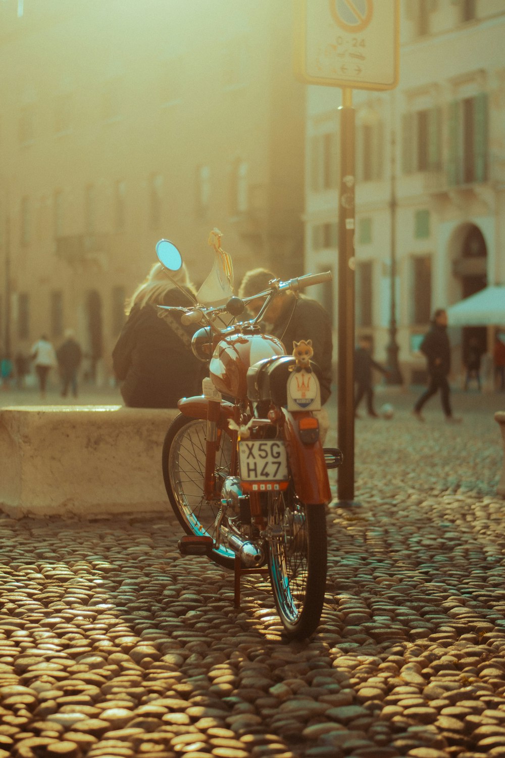 a motorcycle parked on a cobblestone street