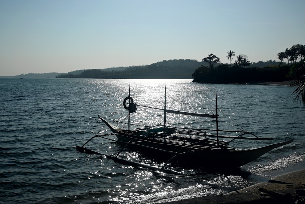 a boat sitting on top of a body of water