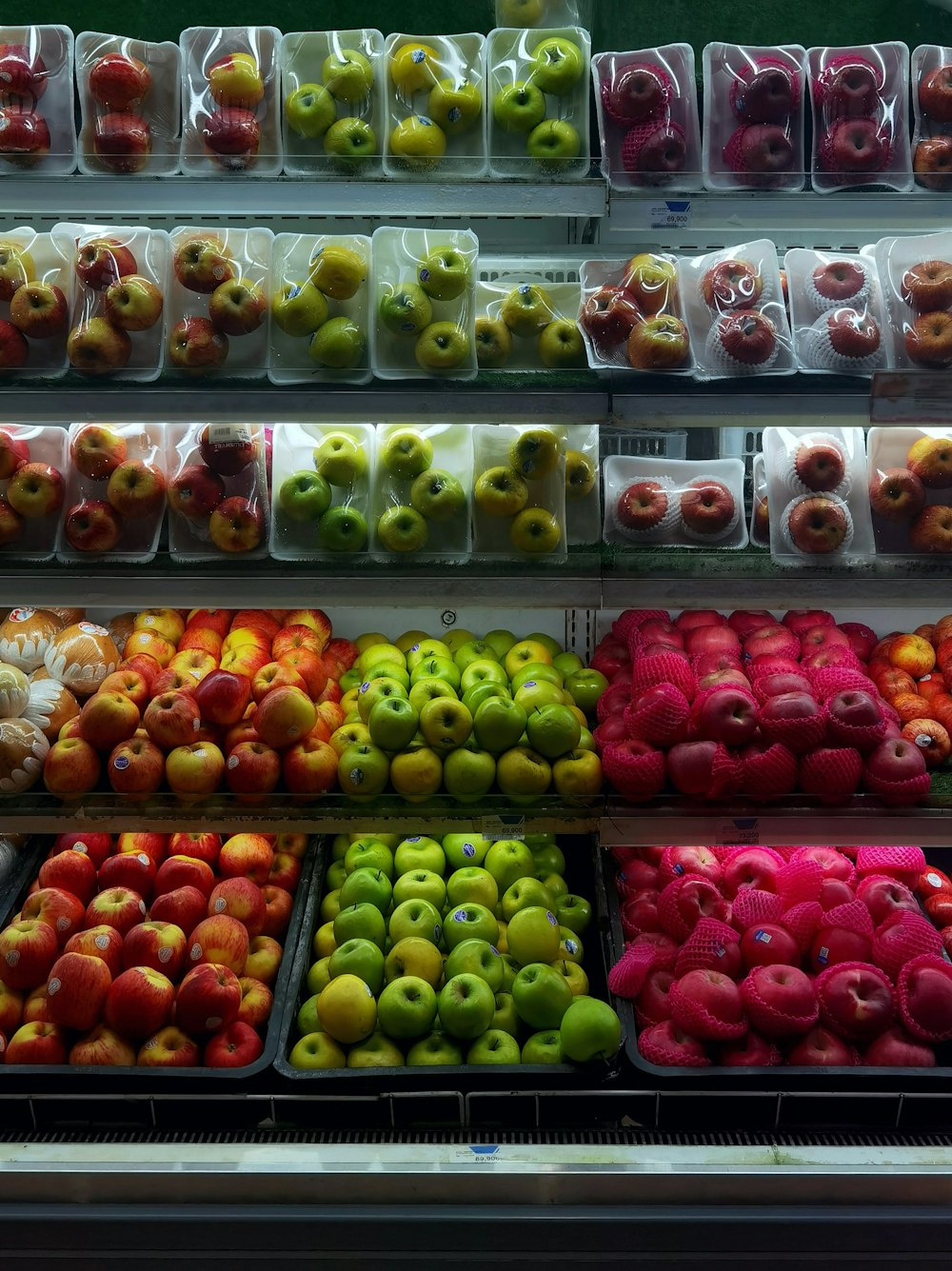 a display case filled with lots of different types of fruit