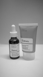 a bottle of lotion next to a tube of lotion