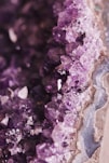 a close up of a rock with purple crystals