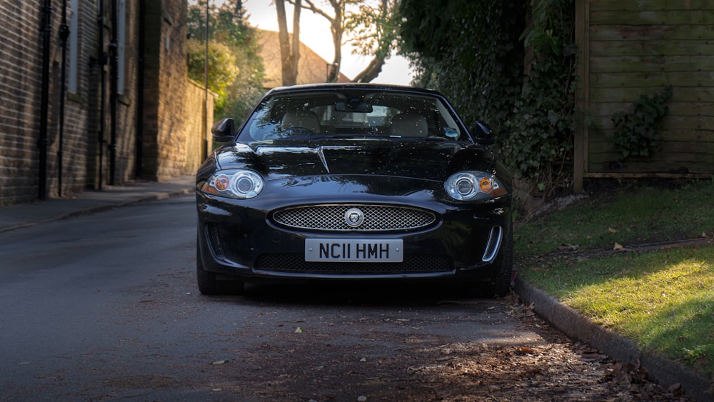 a black car parked on the side of a road