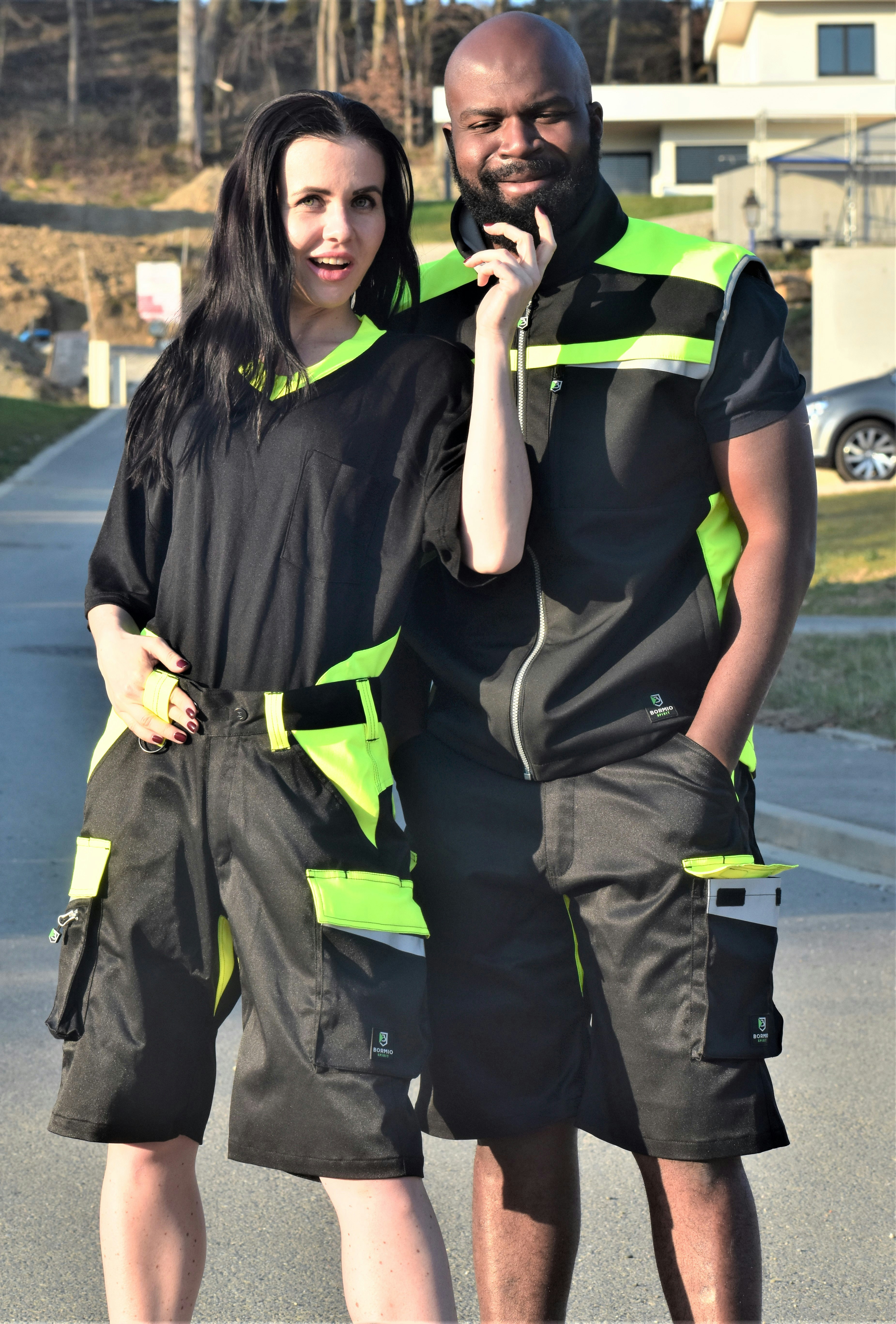 Smiling tradesperson in work clothes, bright outdoor setting