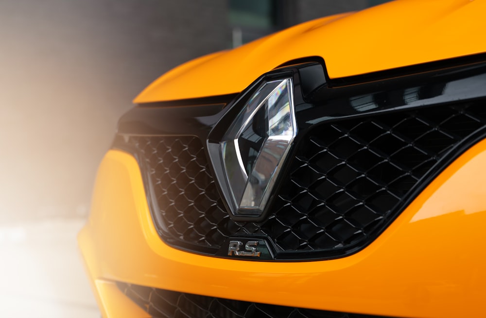 a close up of the front grill of a yellow sports car