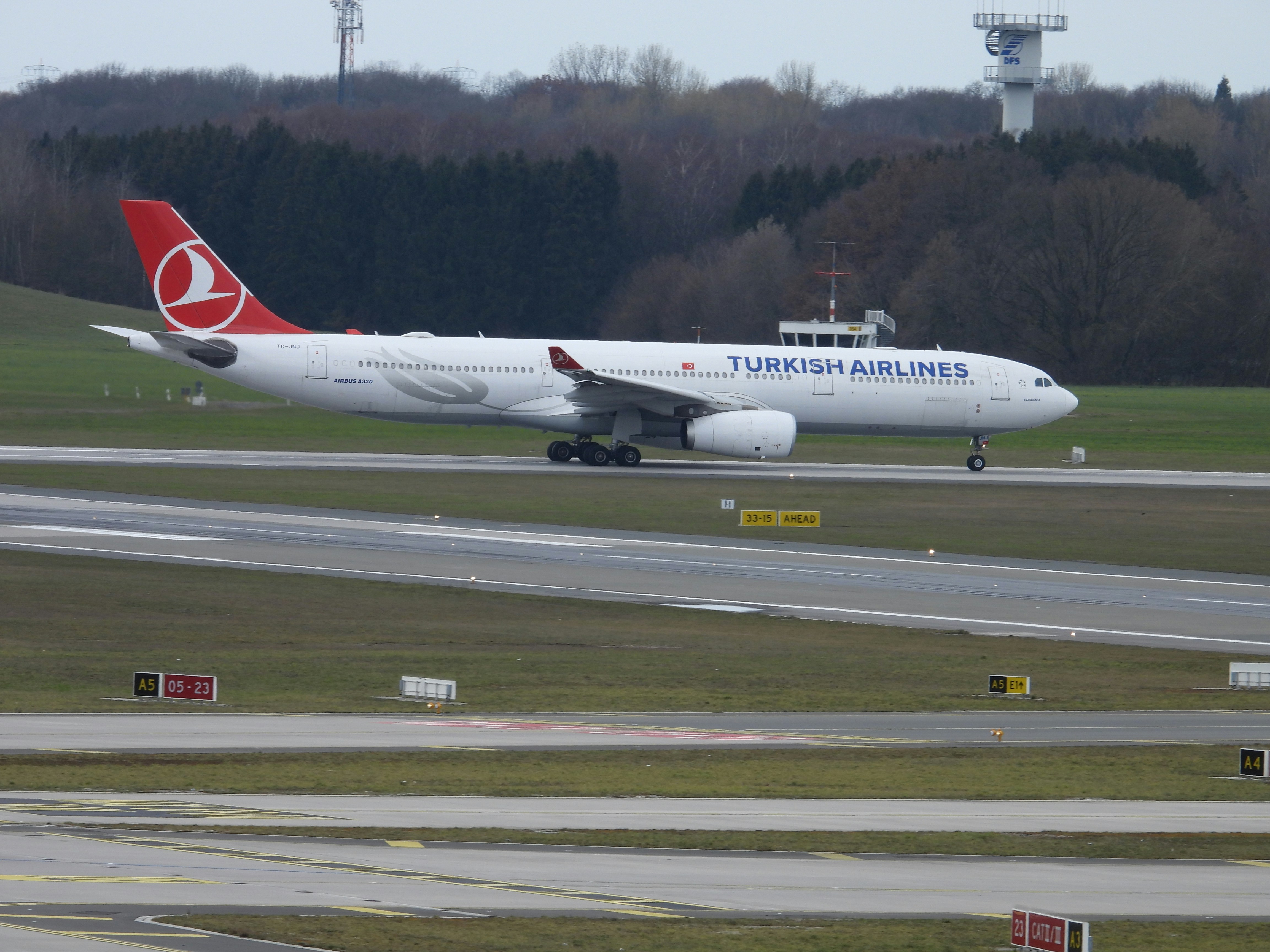 a large jetliner sitting on top of an airport runway, 