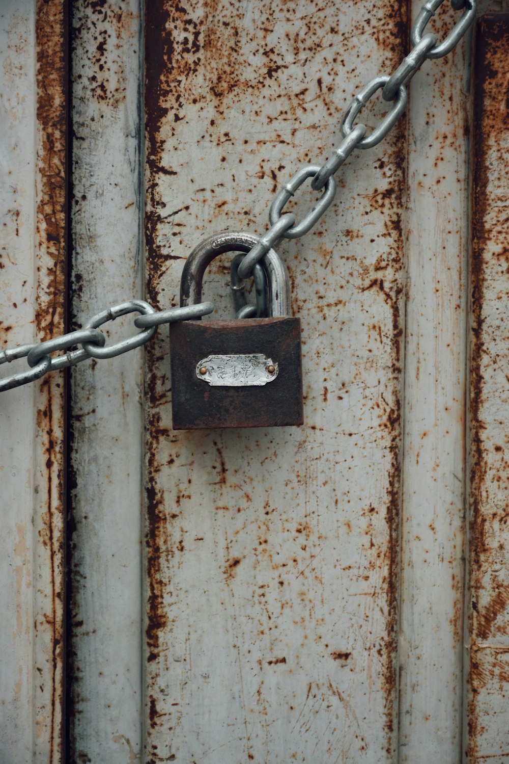 a padlock attached to a chain on a door