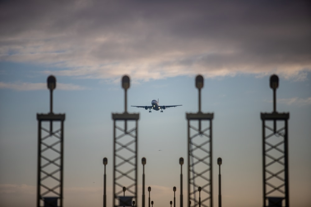 an airplane is flying low over a parking lot