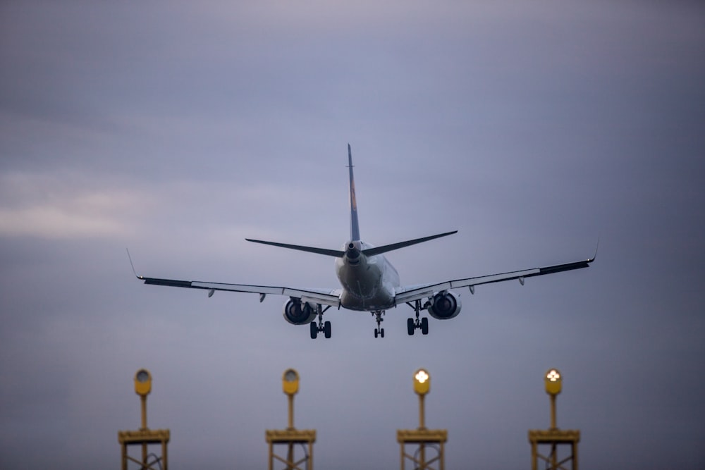 a large jetliner flying through a cloudy sky