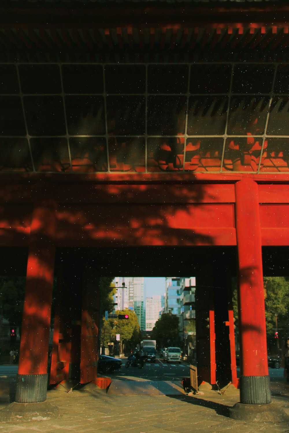 a large red building with a car parked under it