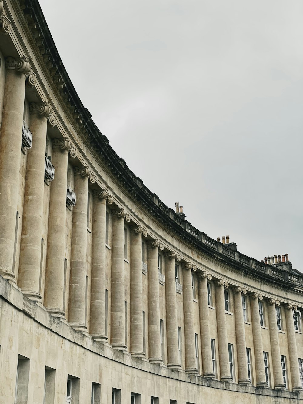 a curved building with a clock on the front of it