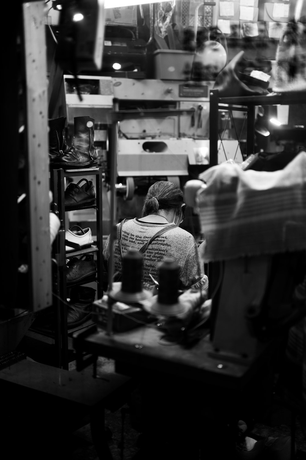 a black and white photo of a man working on a machine