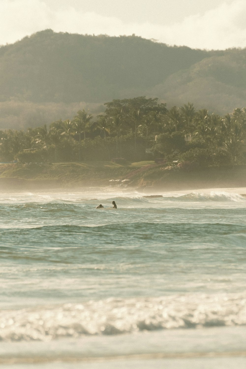 a person riding a surfboard on a wave in the ocean