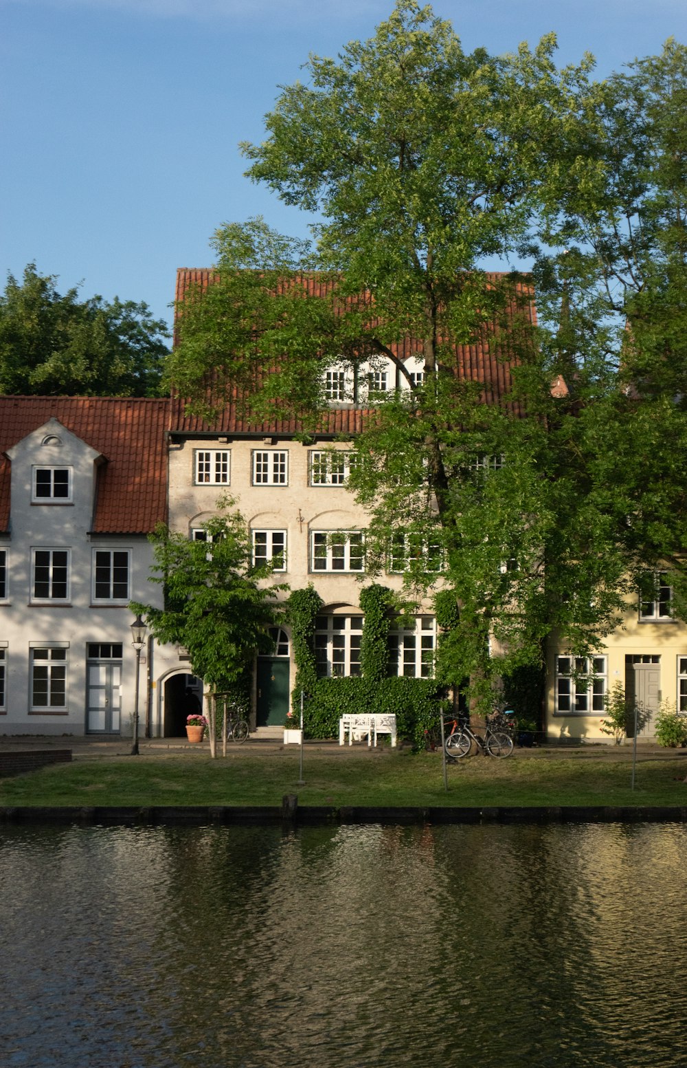 a large white house sitting next to a body of water