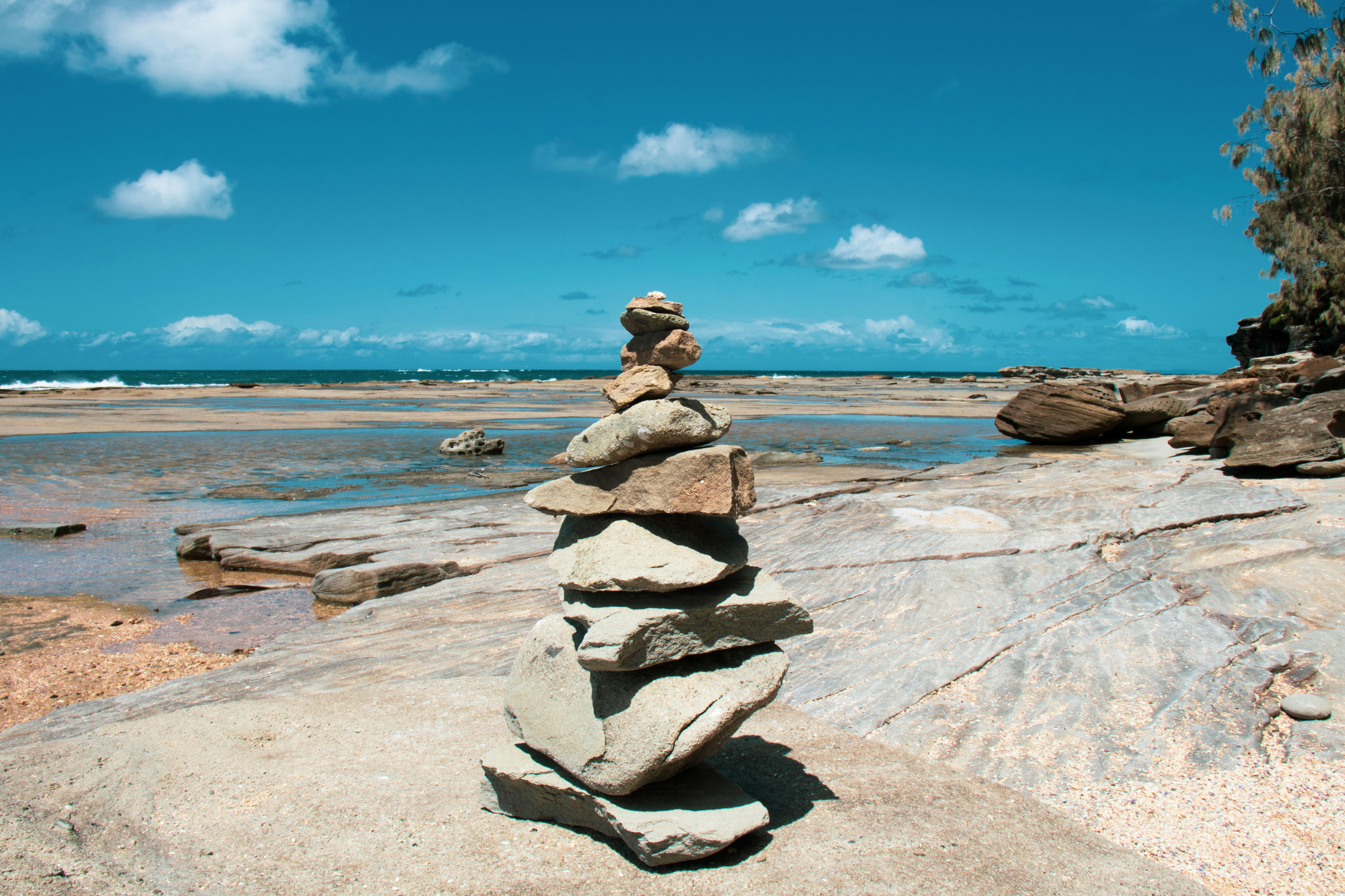 a stack of rocks sitting on top of a beach
