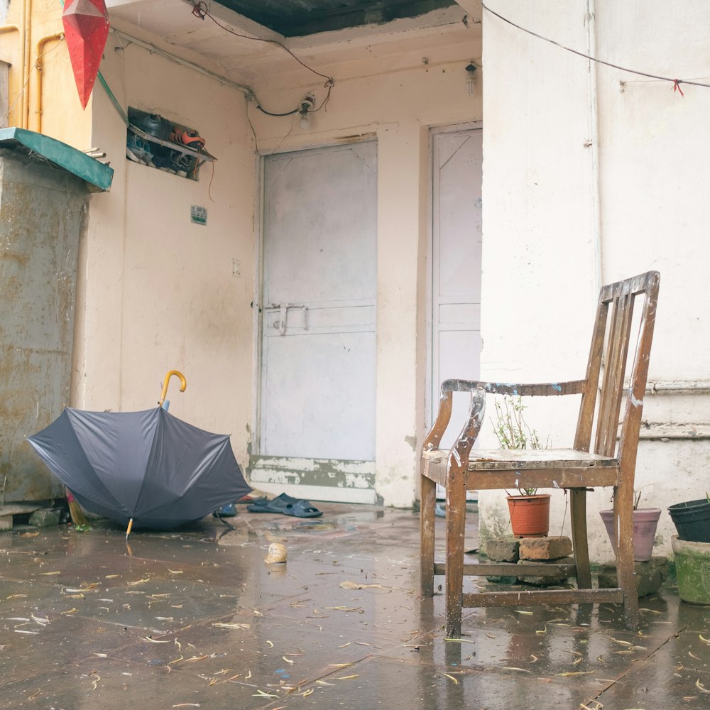 a chair and an umbrella on a rainy day