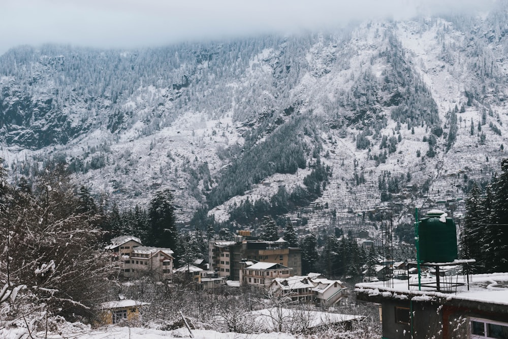 a snow covered mountain with a village in the foreground