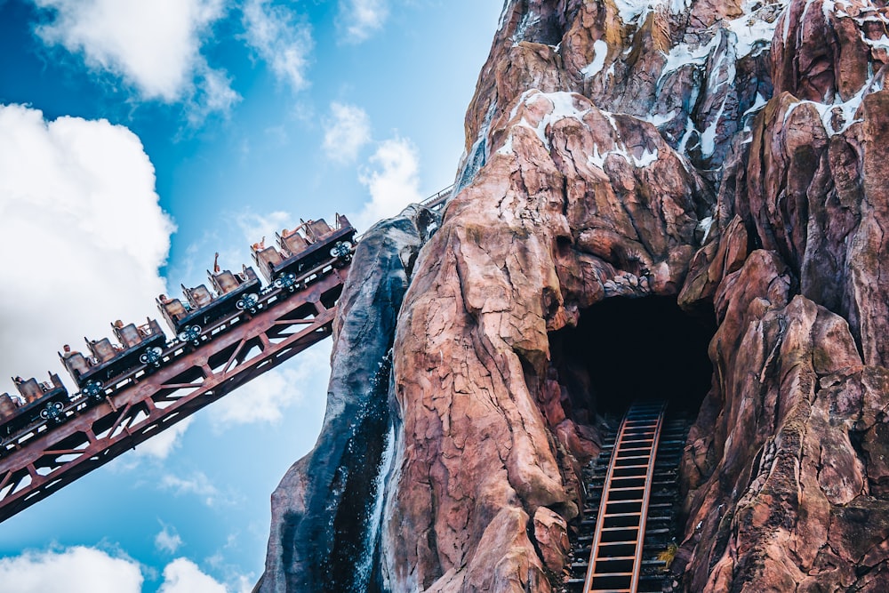 a roller coaster going up the side of a mountain