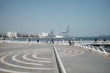 People enjoying the waterfront promenade near the circuit.