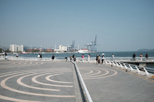People enjoying the waterfront promenade near the circuit.